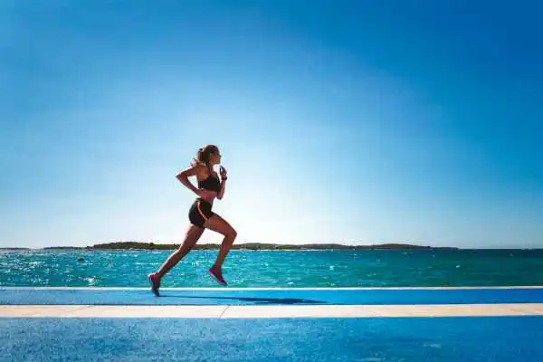 Woman running showing strong leg muscle Solihull Lodge